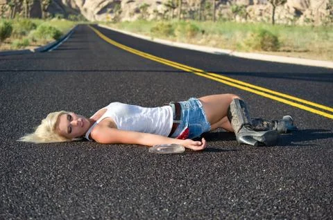 Blond drunk on highway Stock Photos