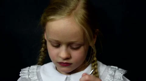 Blond girl eat yogurt on a black background Stock Footage 59449982