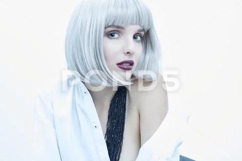 Blond girl with strong make up and a shirt Stock Photos
