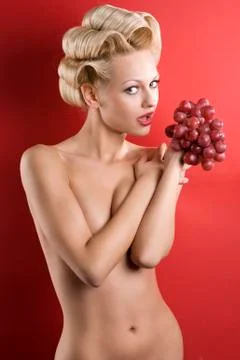 The blond with grape Stock Photos