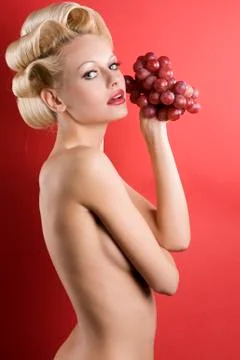 The blond with grape Stock Photos