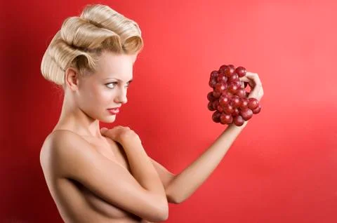 The blond with grape Stock Photos