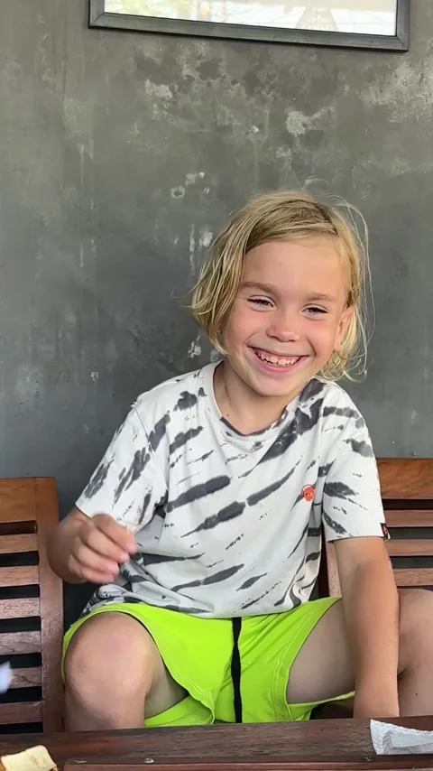 A blond handsome boy smiles Stock Footage 255690029
