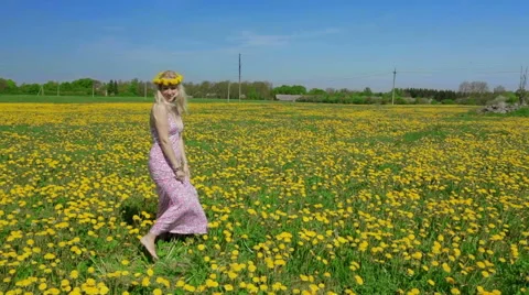 Blond lady is showing us beautiful yellow meadow. Stock Footage 49828443
