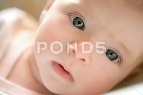 Blond little baby laying on bed portrait Stock Photos