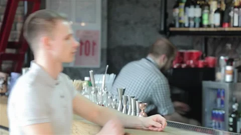 Blond man orders a refreshing beer at the bustling bar Stock Footage 311639664