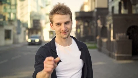 Blond man smiling and pointing at camera 스톡 동영상 97907592