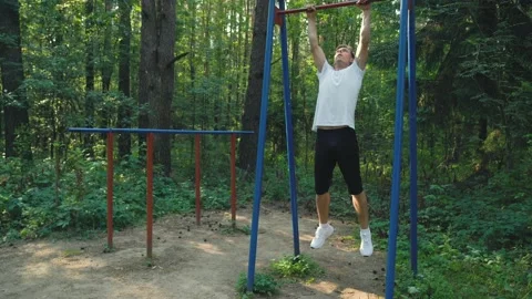 Blond man throwing the log before starting to do sports. Man is doing a warm-up Stock Footage 157070822