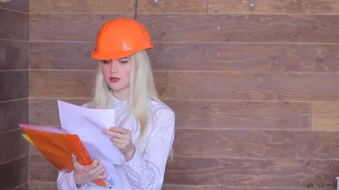 Blond manager with documents, young young woman architect inspects the Stock Footage 84830952