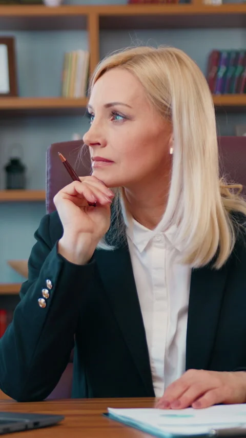 Blond serious doubtful smart senior middle aged old woman looking pensive or con Stock Footage 333191262