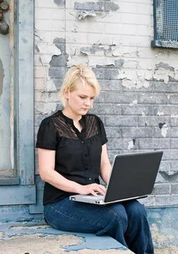 Blond Woman Doing Computer Work in Urban Scene Stock Photos