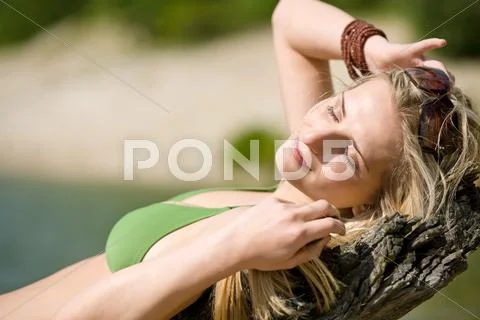 Blond woman relax in bikini at lake Stock Photos