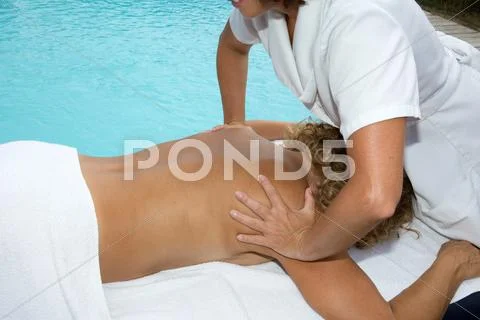 Blond woman relaxing with hand massage at beauty spa, closeup Stock Photos