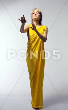 Blond woman in yellow veil play role Stock Photos