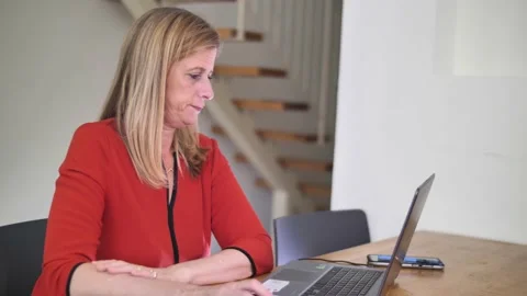 Blond women typing on a computer Stock Footage 130897951