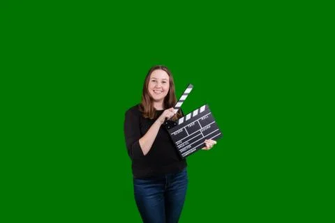 Blond women using a clapper board smiling on green screen background Stock Photos