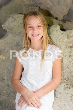 Blond young girl teen outside smiling at camera Stock Photos