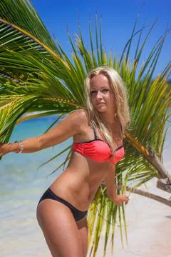 Blonde and palm leaf at the Bavaro beach Stock Photos