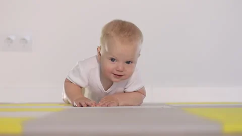 Blonde babe learns to crawl Stock Footage 162543554
