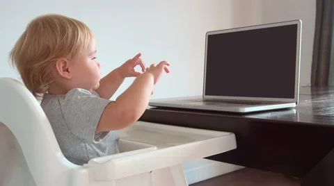 Blonde baby touching blank screen pc Stock Footage 44123024