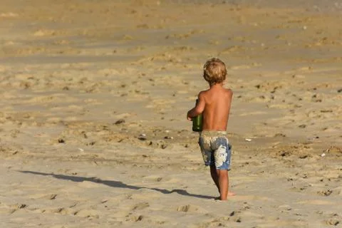 Blonde Beach Boy With Empty Beer Bottle Stock Photos