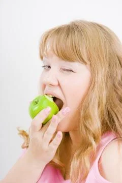 Blonde bites the apple Stock Photos
