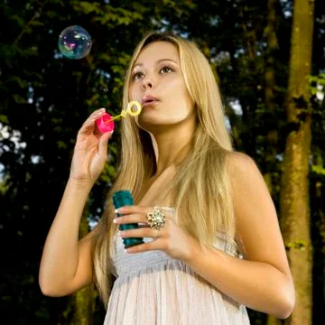 Blonde blowing soap bubble 스톡 사진