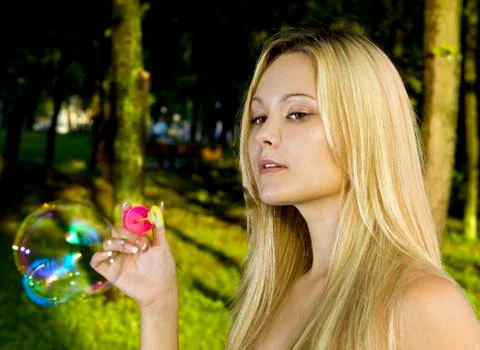 Blonde blowing soap bubbles Stock Photos