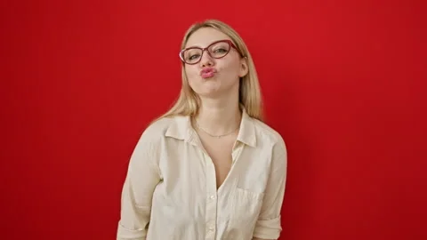 Blonde bombshell in specs, adorable young woman playfully sends love, blowi.. Stock Footage 270311319
