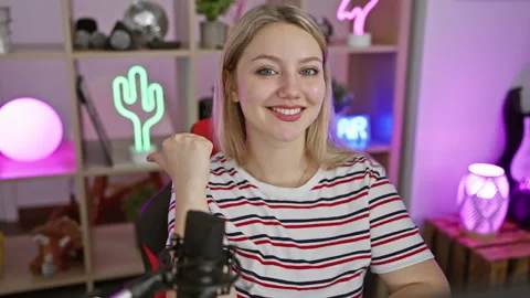 Blonde bombshell streamer owning the night, confident smile elucidating her.. Stock Footage 271050692