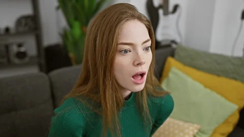 Blonde bombshell in a sweater stunned at home, a saga of shock, fear and ex.. Stock Footage 276540685