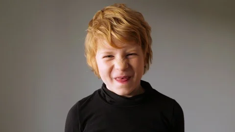 Blonde boy grimaces on camera 스톡 동영상 123619966