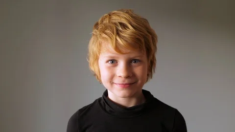 Blonde boy grimaces on camera Stockbeeldmateriaal 123619987