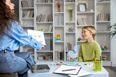 Blonde boy having a speech tutorial with a female speech therapist Stock Photos