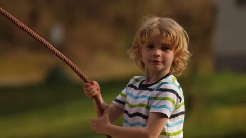 Blonde boy plays in the playground 库存影片 151657922