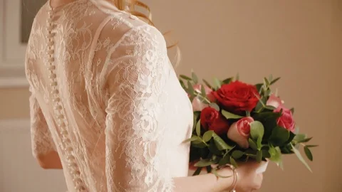 The blonde bride in a wedding dress with flowers posing for the camera Stock Footage 102188053