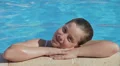 Blonde child girl in swimming pool HD Footage