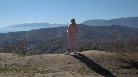 The blonde is on a cliff Stock Footage 105940562