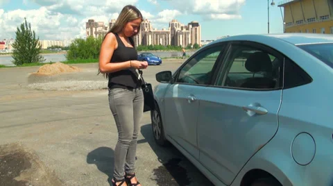 Blonde closes car Stock Footage 29661768