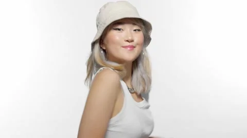 Blonde corean model turns fast to the camera and making faces and hand v sign Stock Footage 136821392