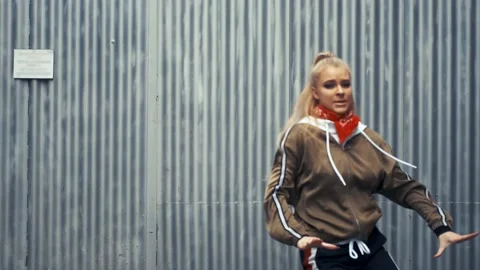 Blonde dancing against the wall. Stock Footage 141002347