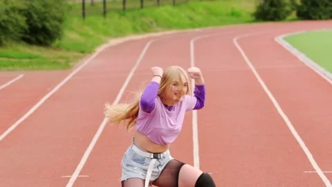 Blonde dancing twerk on a stadium treadmill Stock Footage 139528385