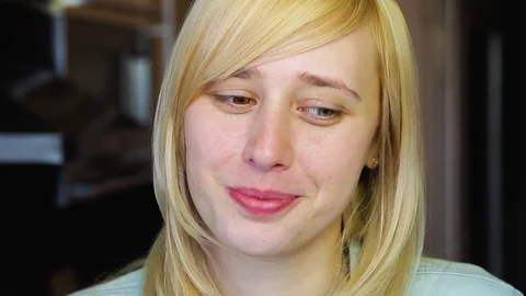 Blonde with different eyes looks at the camera and smiles 動画素材 73990288