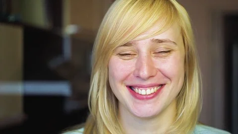 Blonde with different eyes looks at the camera and smiles 動画素材 73990310