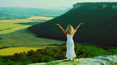 Blonde on the edge of the cliff Stock Footage 820421