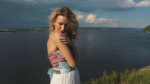 Blonde on the edge of the cliff Stock Footage 78698047