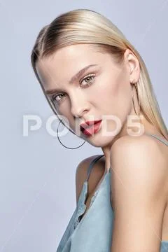 Blonde female on gray background. Stock Photos