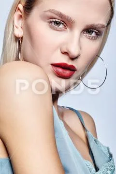 Blonde female on gray background. Stock Photos
