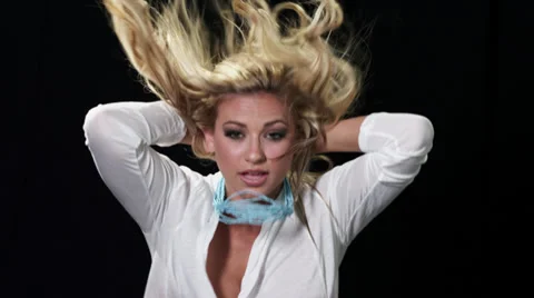 Blonde female model posing in front of a black screen Stock Footage 37839398