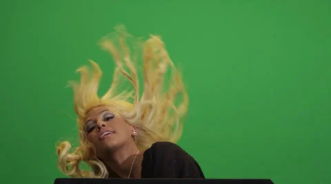 Blonde female model posing in front of a green screen Stock Footage 38192365